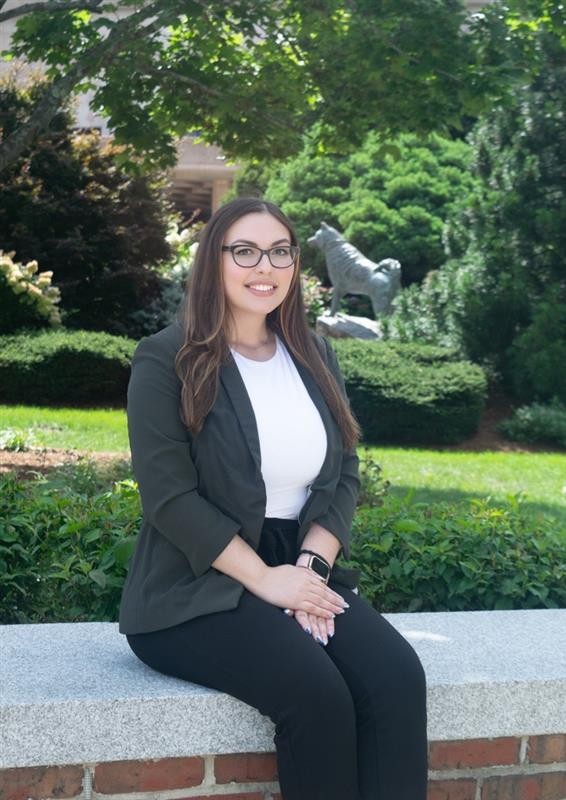Sarah posing with the Husky Dog statue in the background