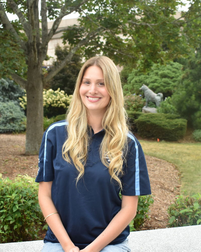 Tessa posing in front of the Husky statue